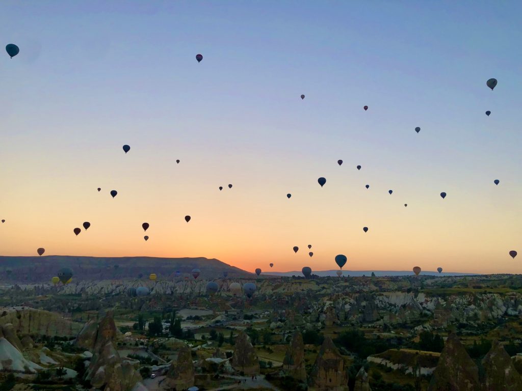 sunrise sky full of hot air balloons