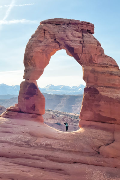 Girl standing under delicate Arch