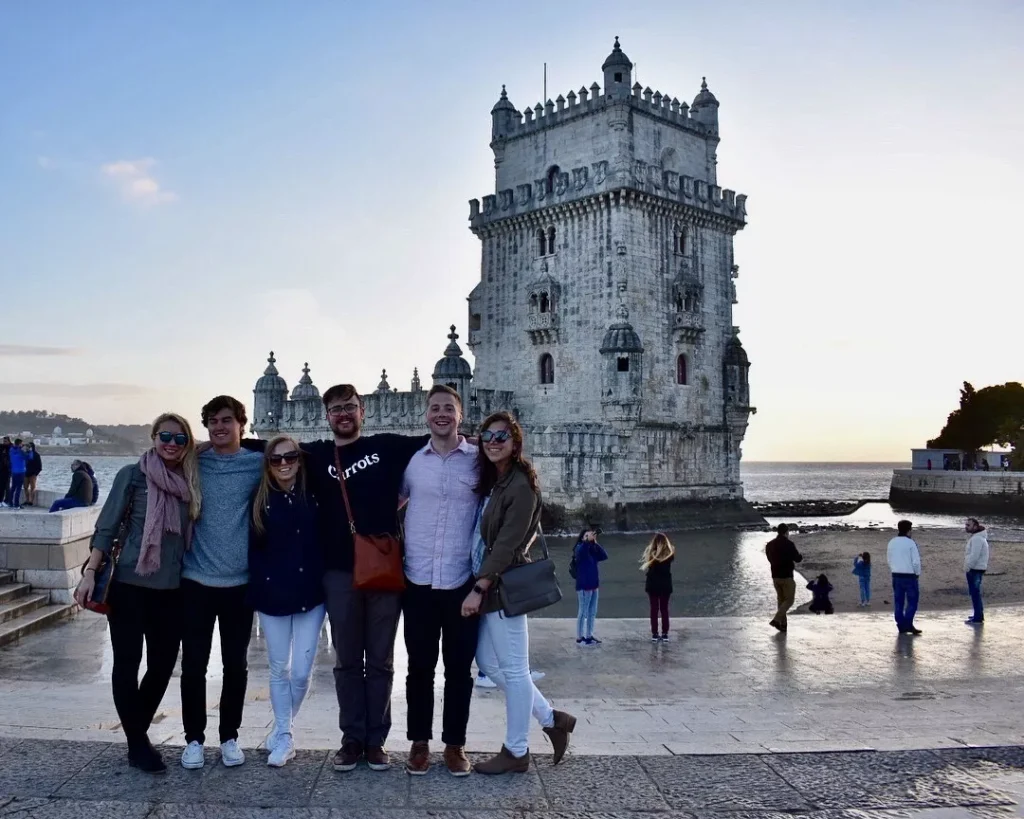 group of people smiling at belem tower