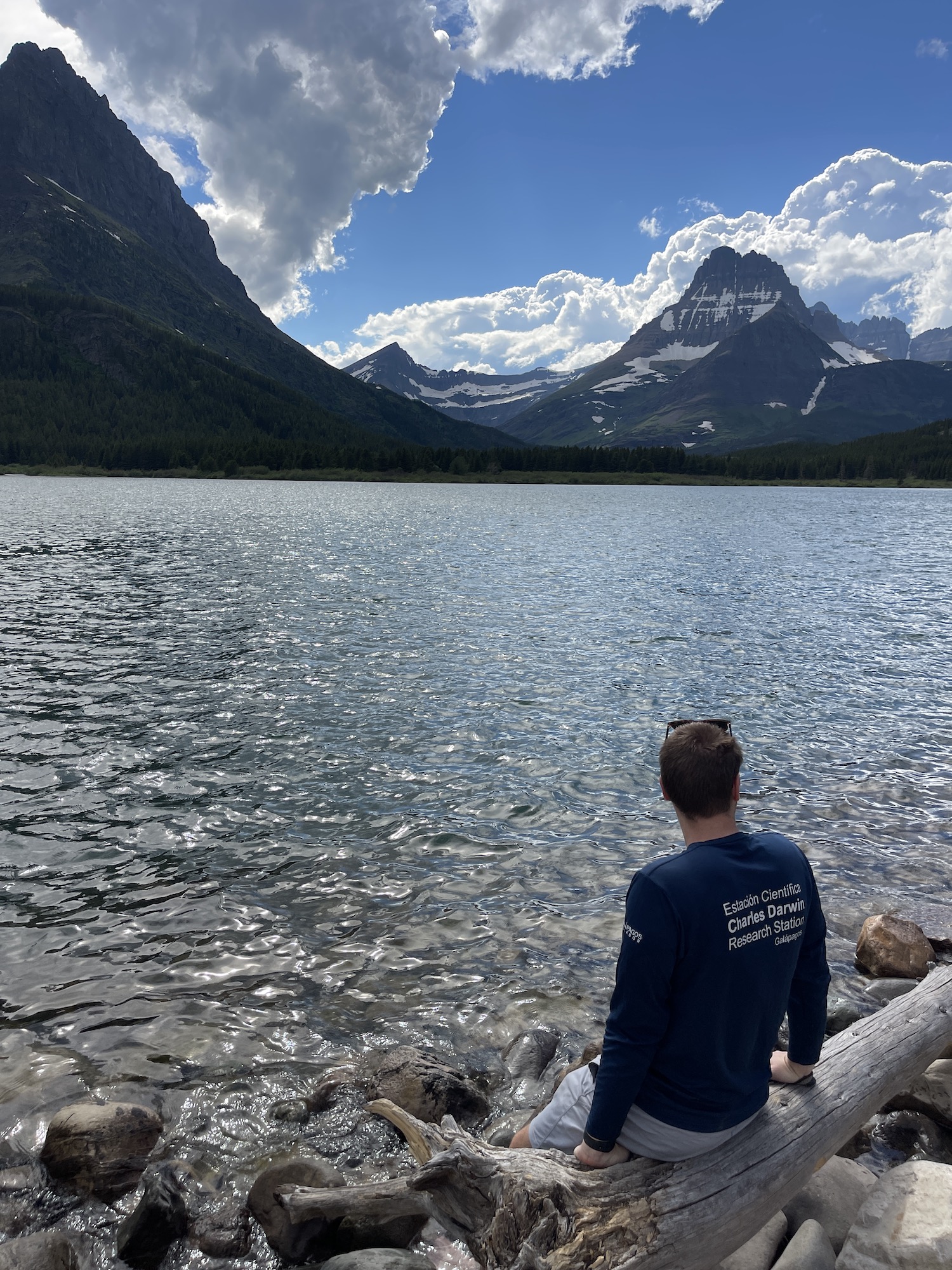 swiftcurrent lake with man in front of it