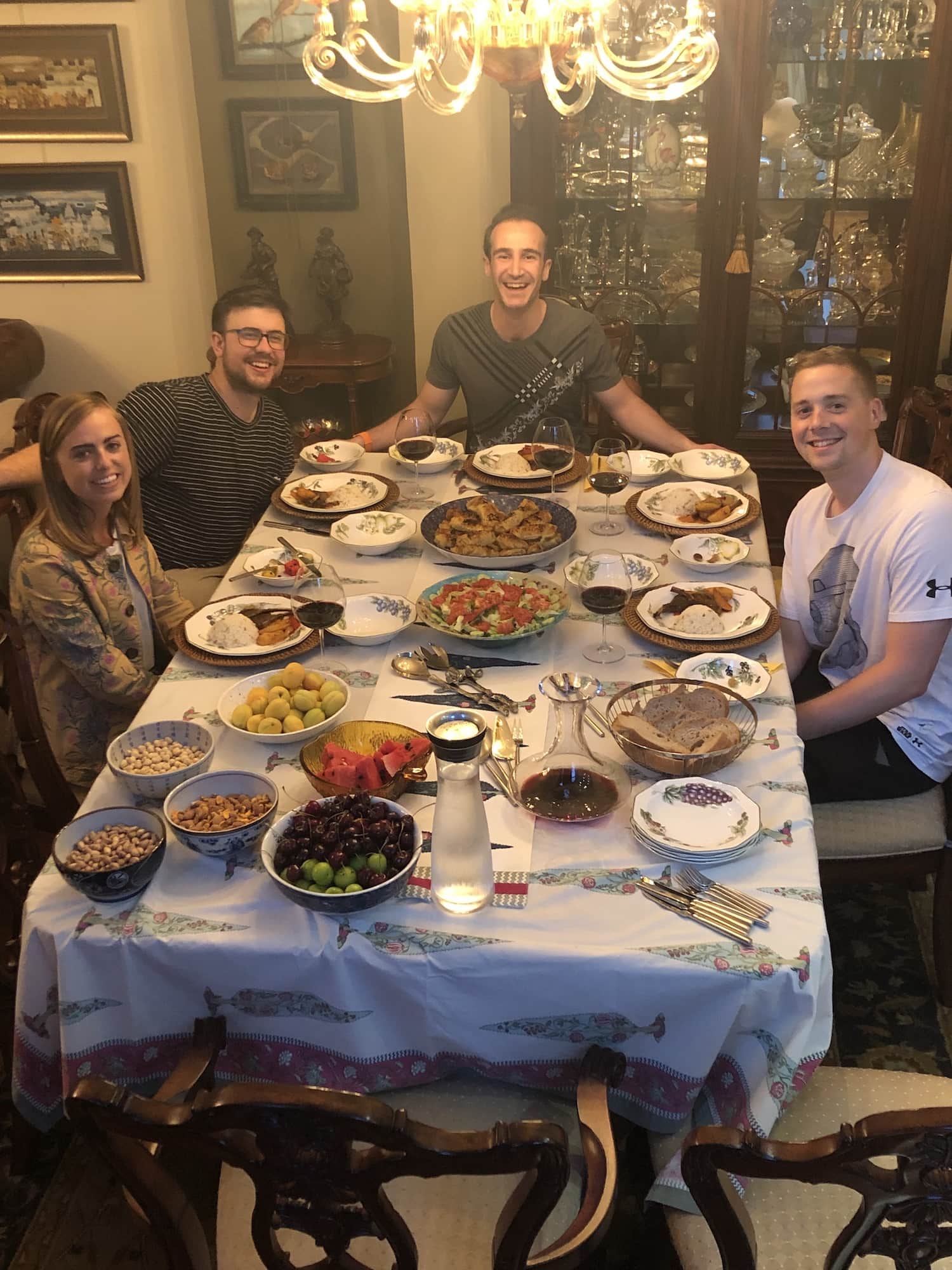 people sitting around a table with turkish food in center