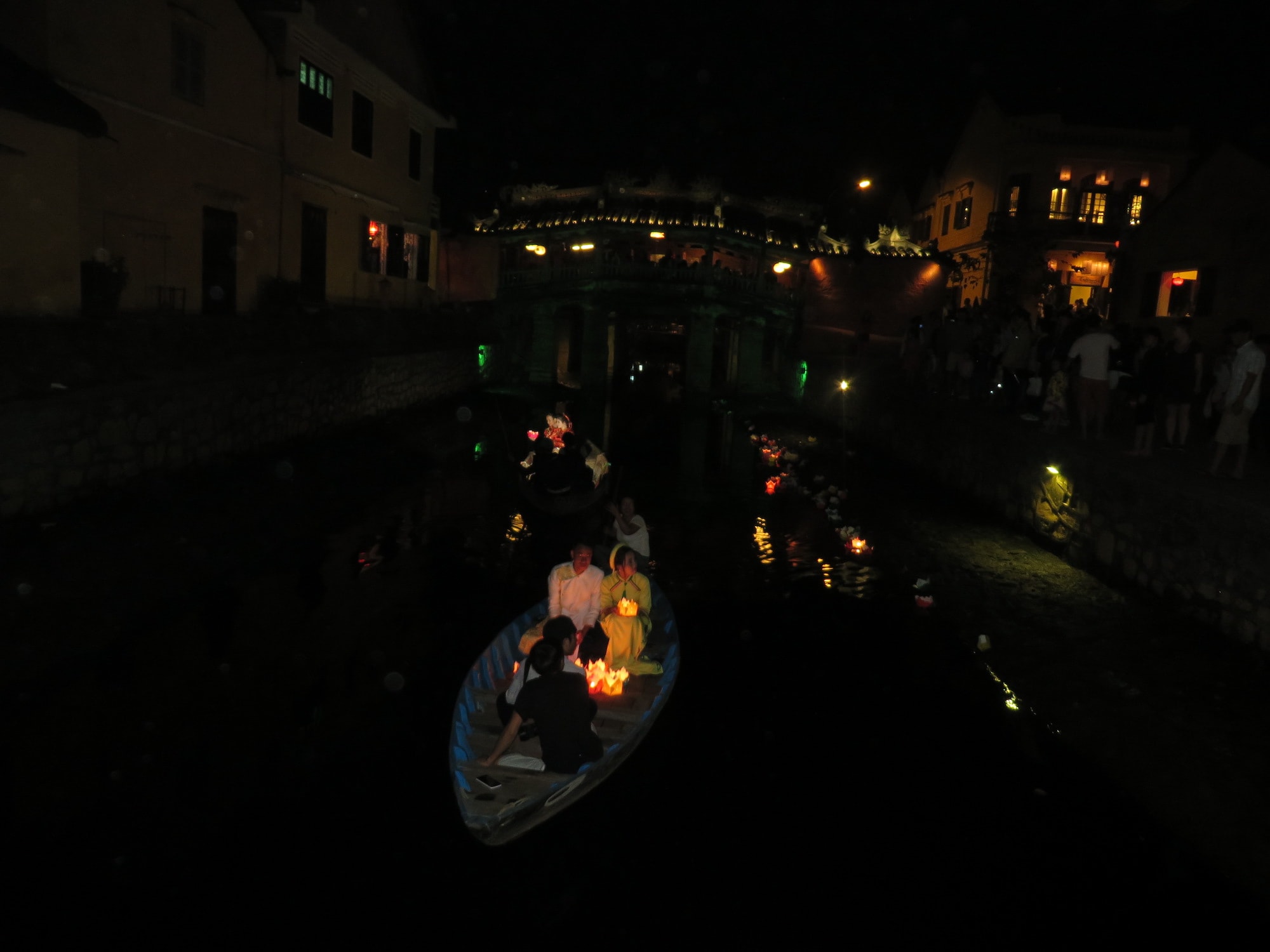 Boats with lanterns lit up at night in Hoi An