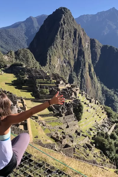 girl sitting in front of machu picchu