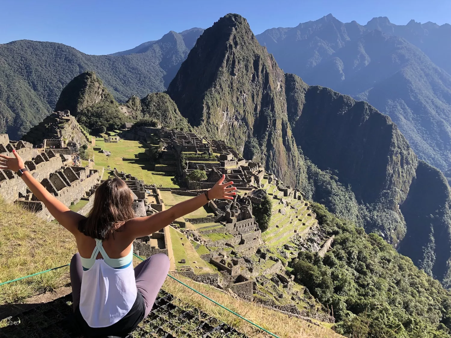 girl sitting in front of machu picchu