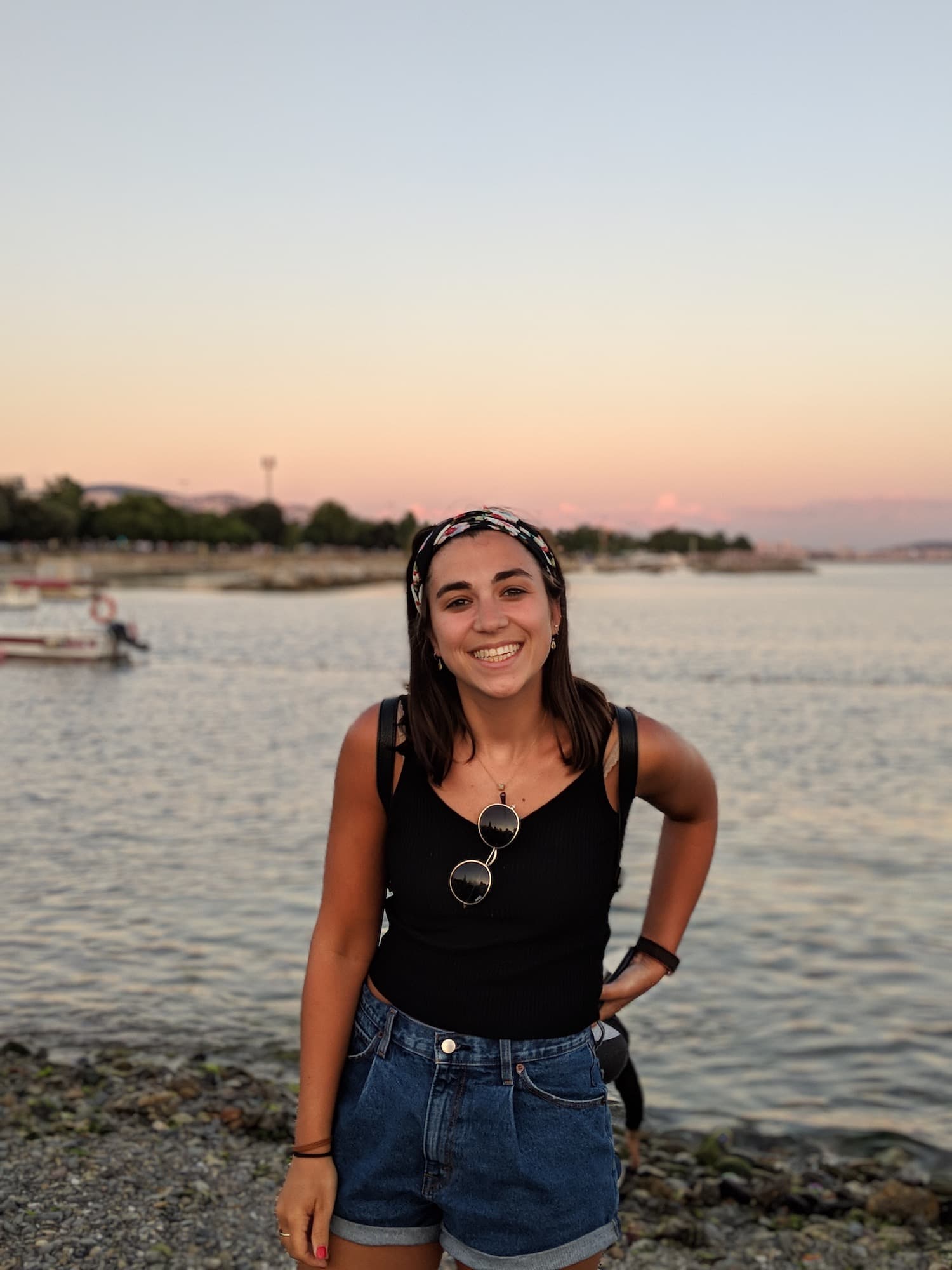 Girl standing in front of the Bosphorous with sunset in back