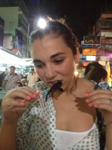 Girl eating scorpion