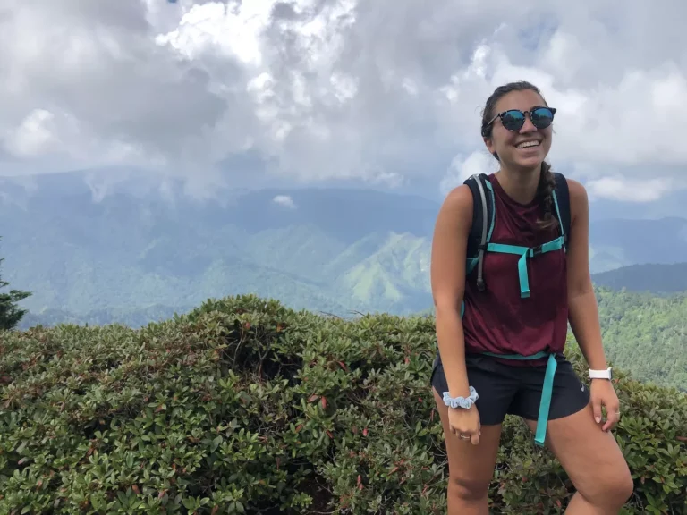 woman smiling on the top of mount leconte in the great smoky mountains
