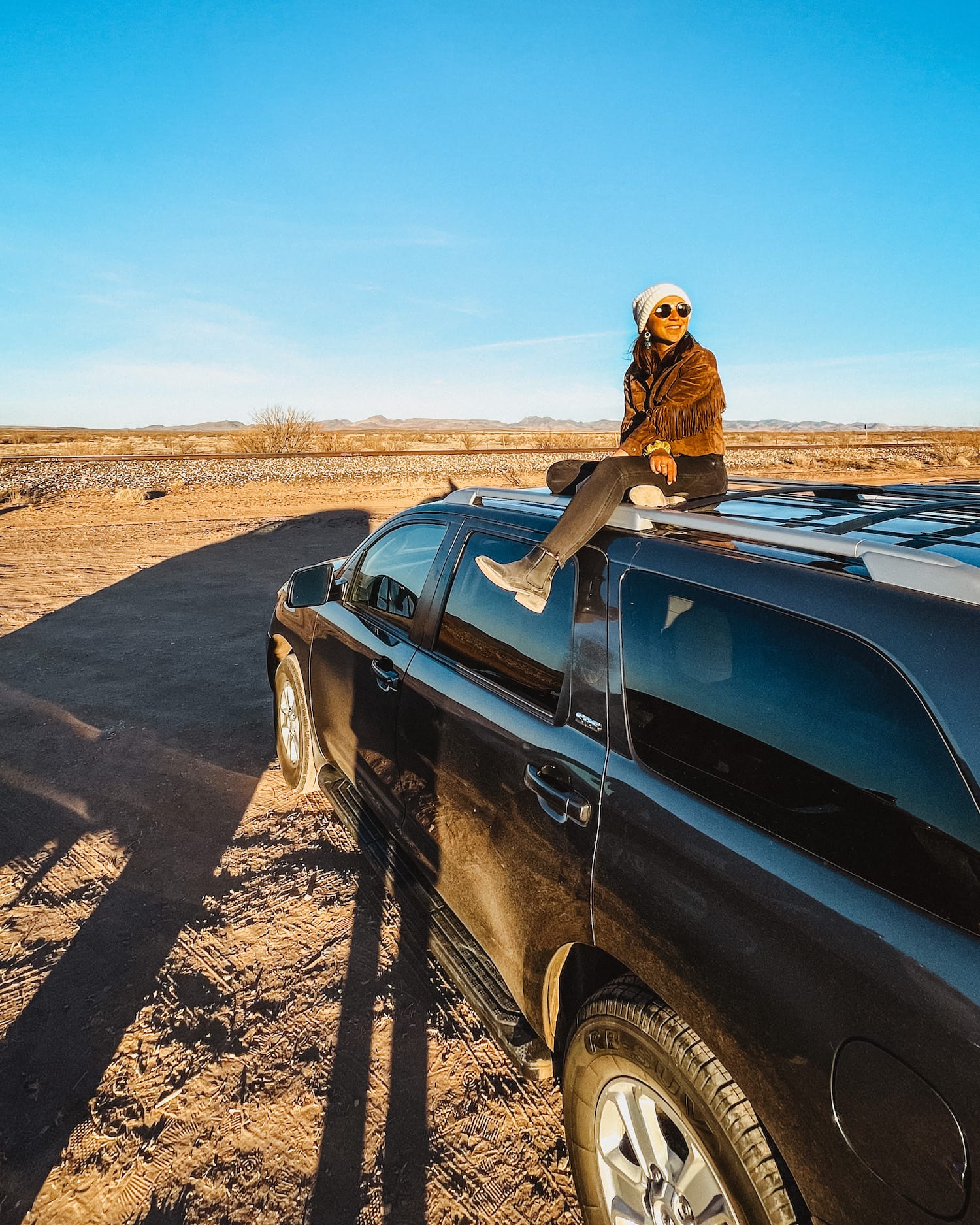 Girl on Car, looking out; road trip to west texas