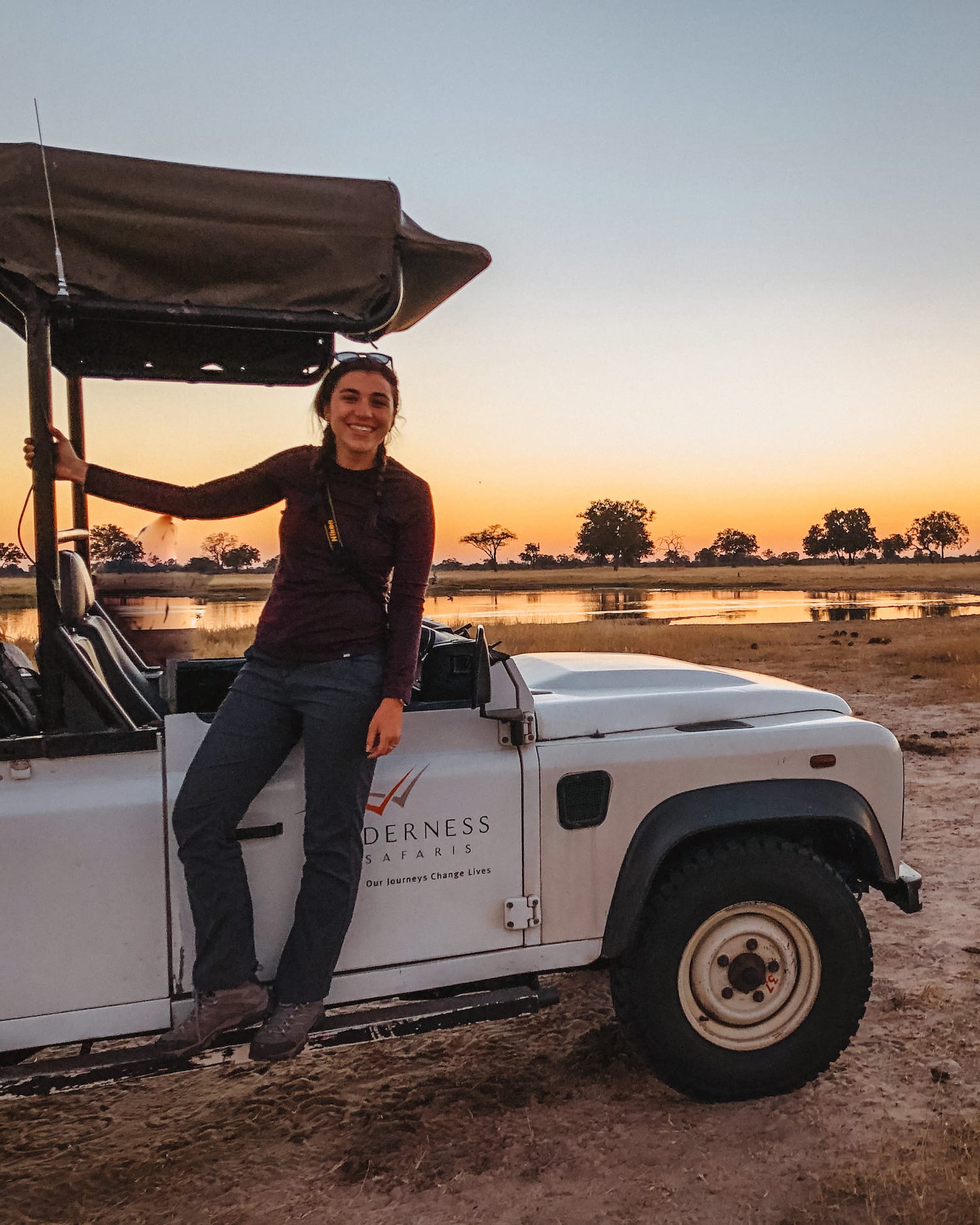 Luxury African Safari Tours cover; Girl standing in front of Jeep