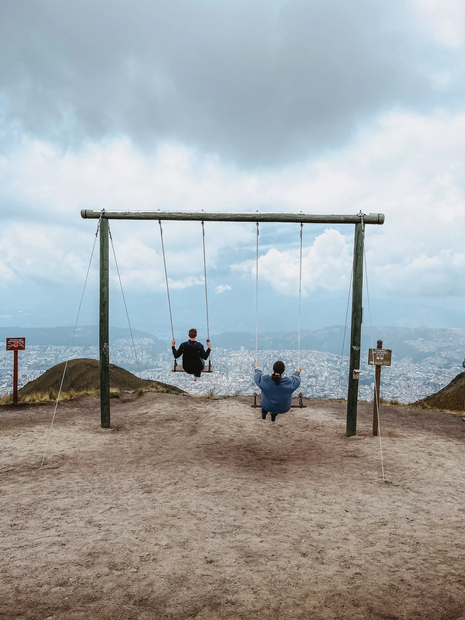 two people swinging over Quito Ecuador