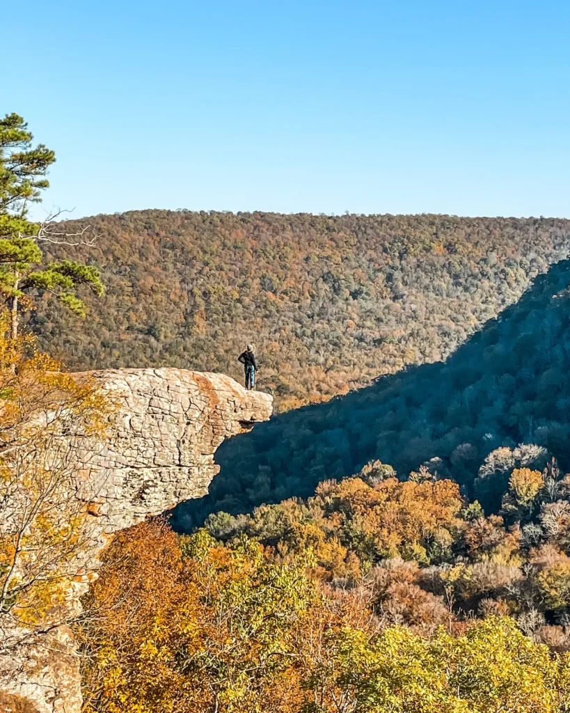 Woman standing on the edge of the rock at Whitaker Point