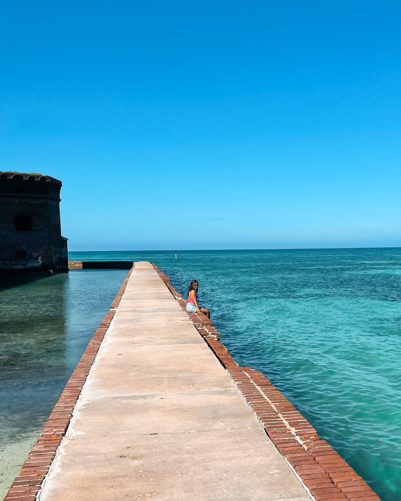 Sitting on moat wall over the water