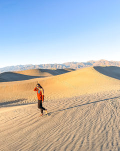 Picture of me standing in the sand dunes; death valley itinerary cover