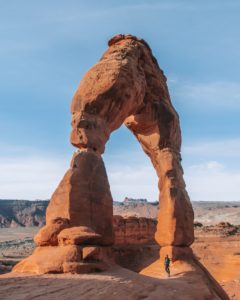 Girl standing in front of delicate arch