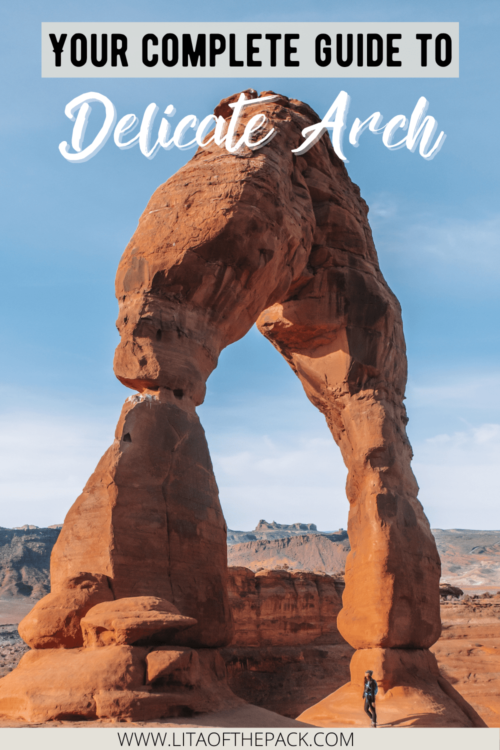 Girl standing in front of Delicate Arch