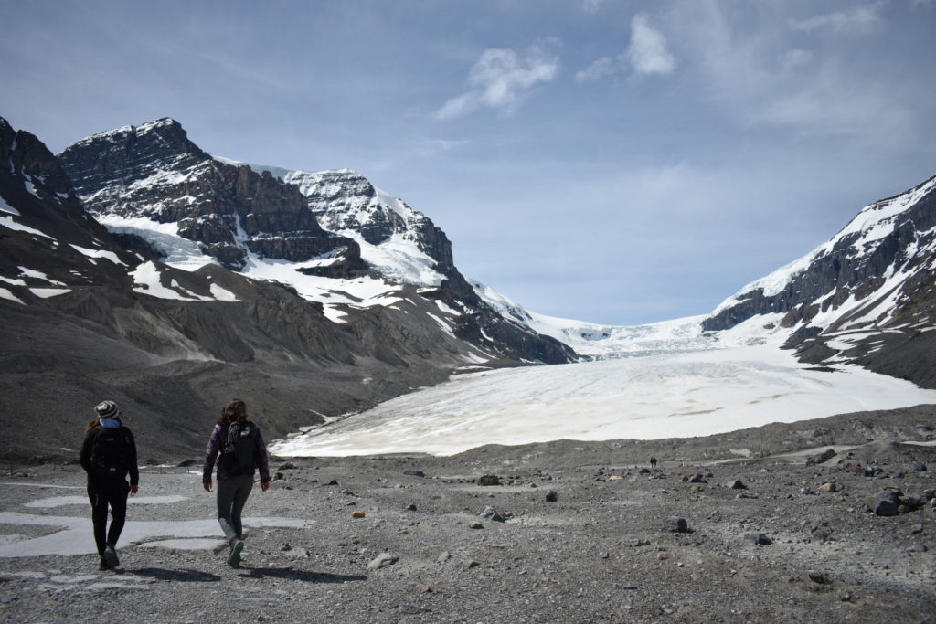 two girls walking by athabasca glacier