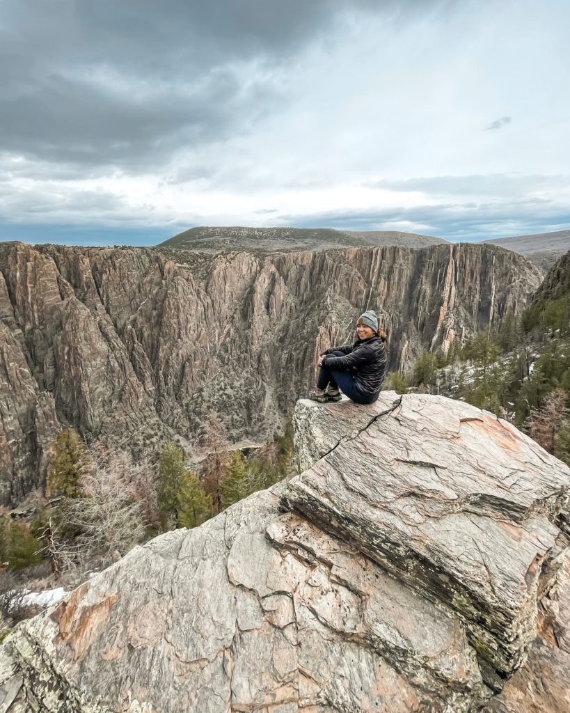 Girl sitting on ledge at Black Canyon of the Gunnison