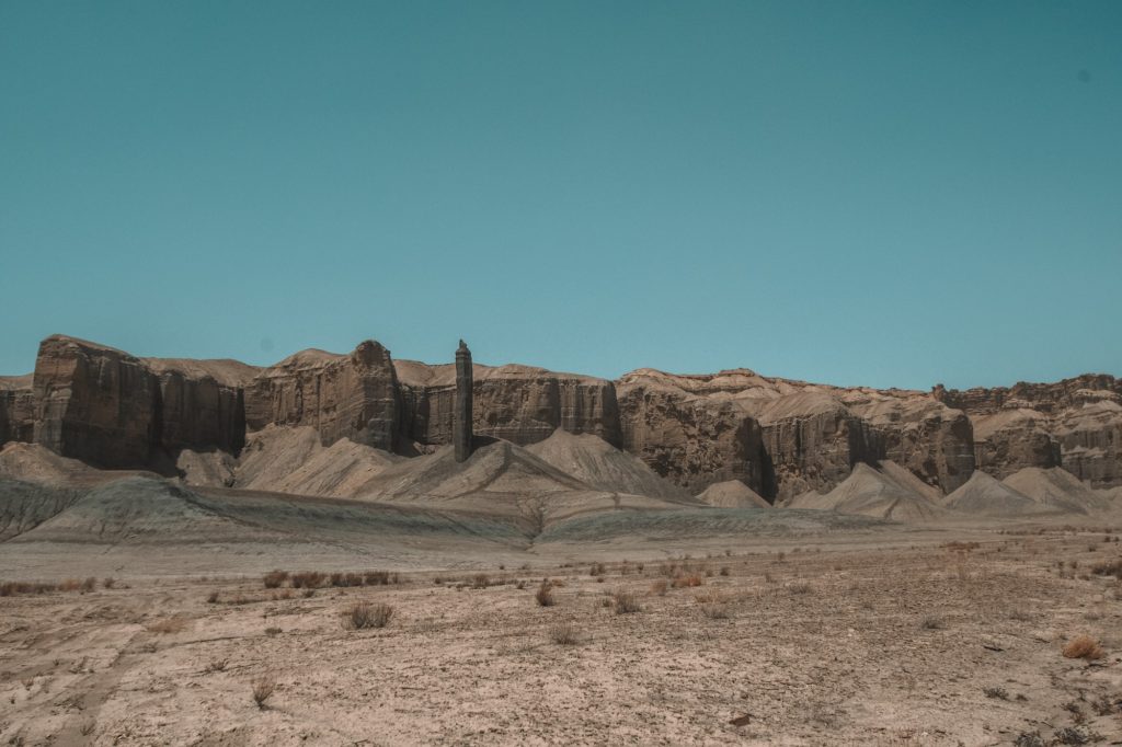 Time lapse tracking shot of Long Dong Silver spire rock over mud