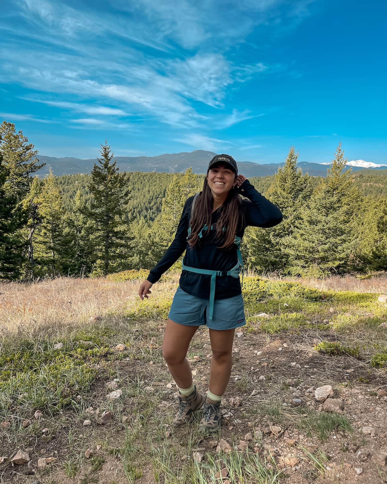 girl smiling on green mountain trail