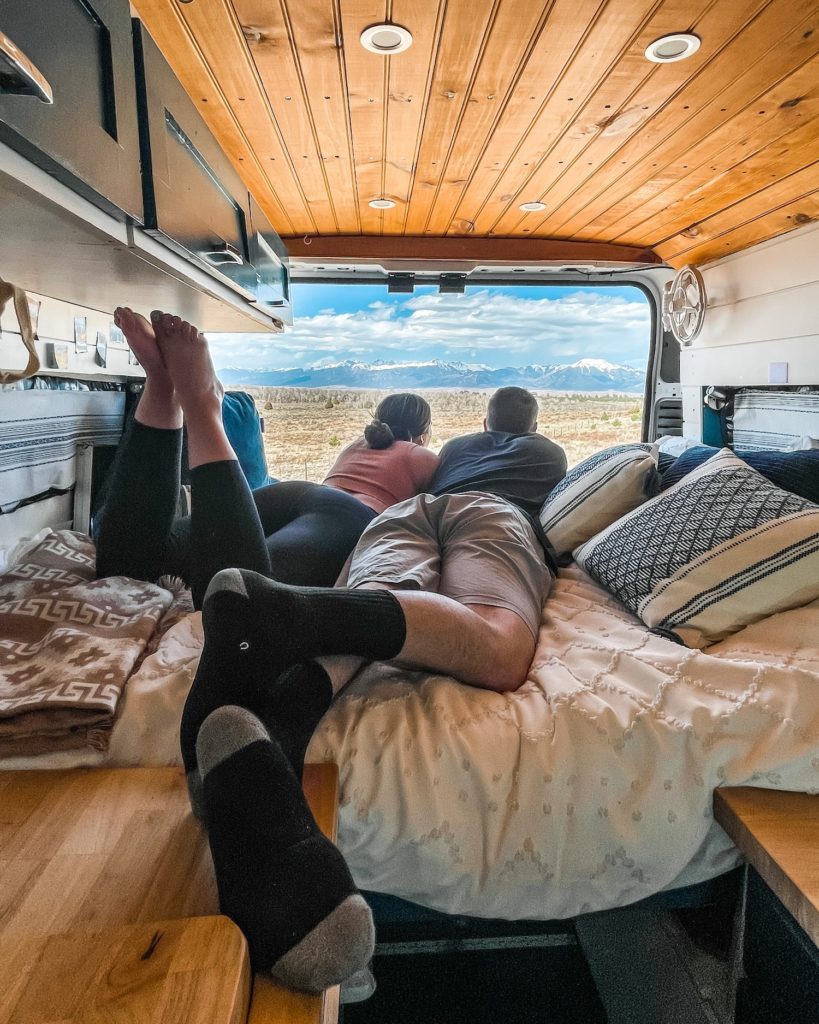 two people on couch in campervan