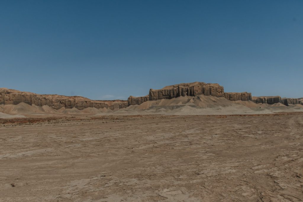 Time lapse tracking shot of Long Dong Silver spire rock over mud