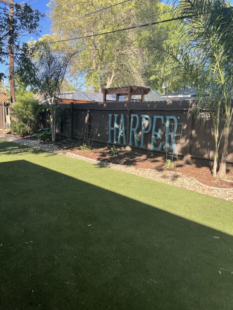 backyard with sign on fence