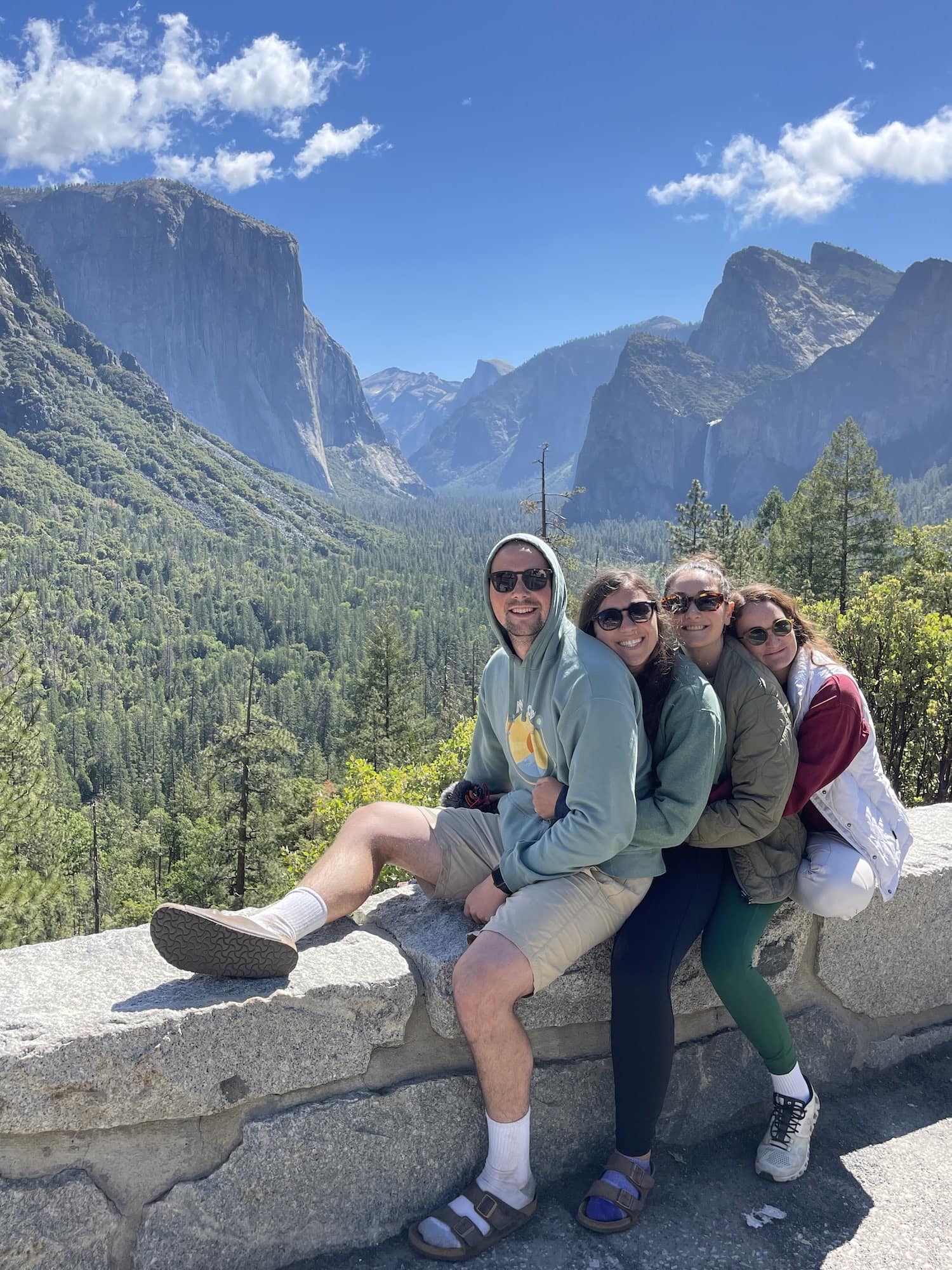 four people hugging at tunnel view yosemite