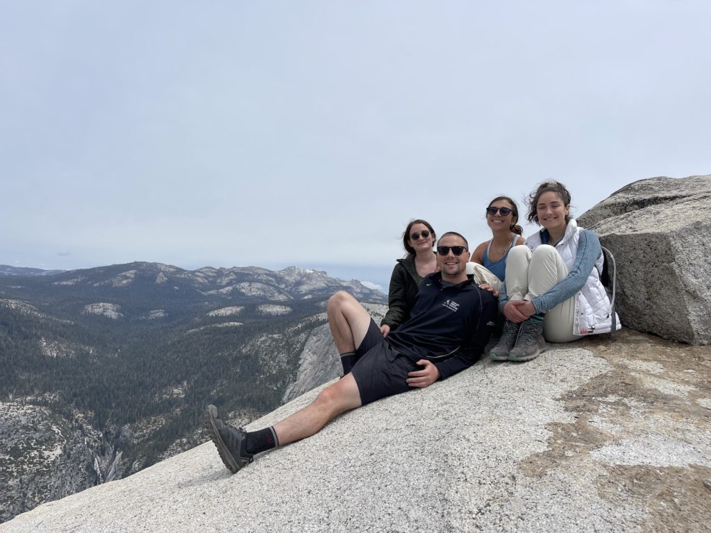 four people sitting at sub dome