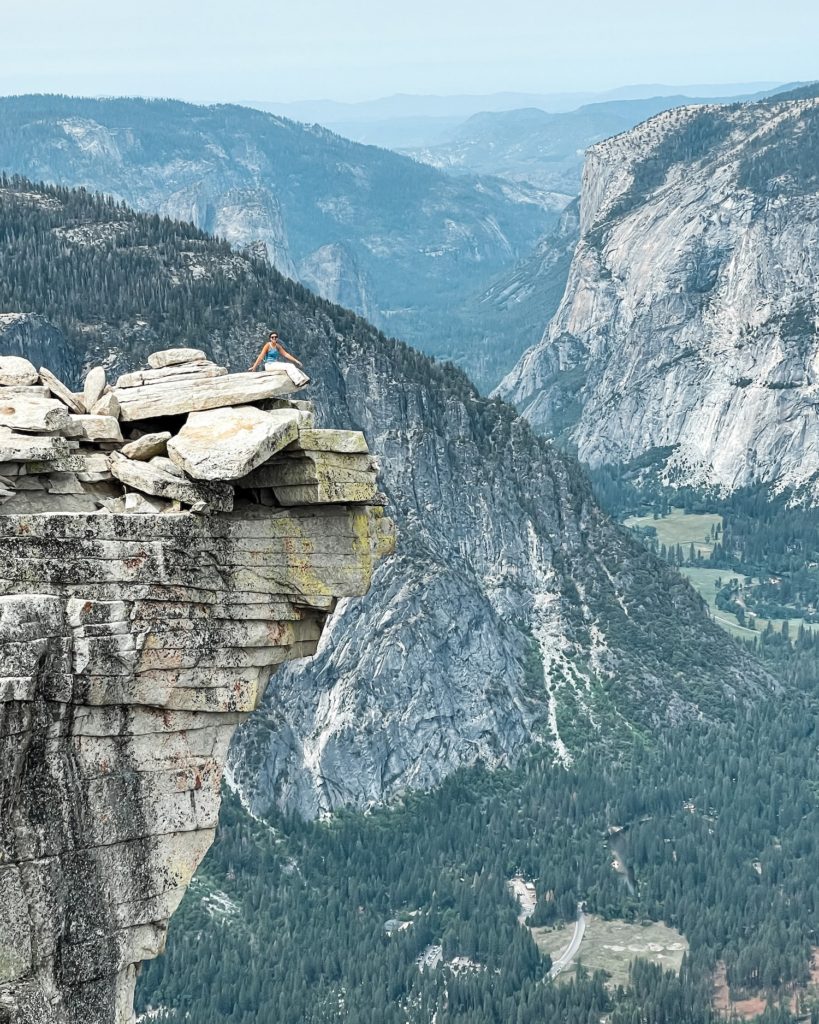 girl sitting on diving board half dome