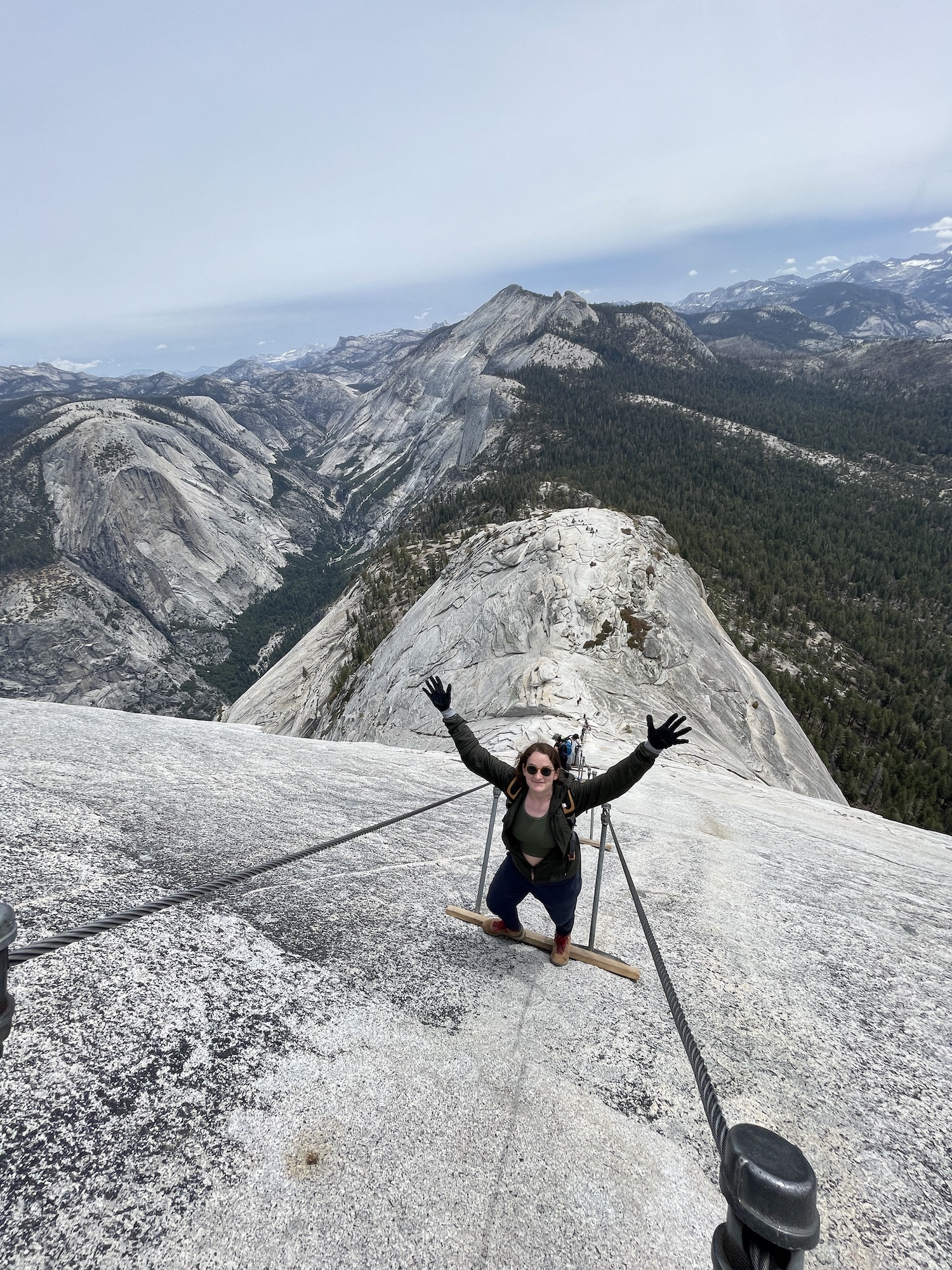 girl celebrating on half dome cables