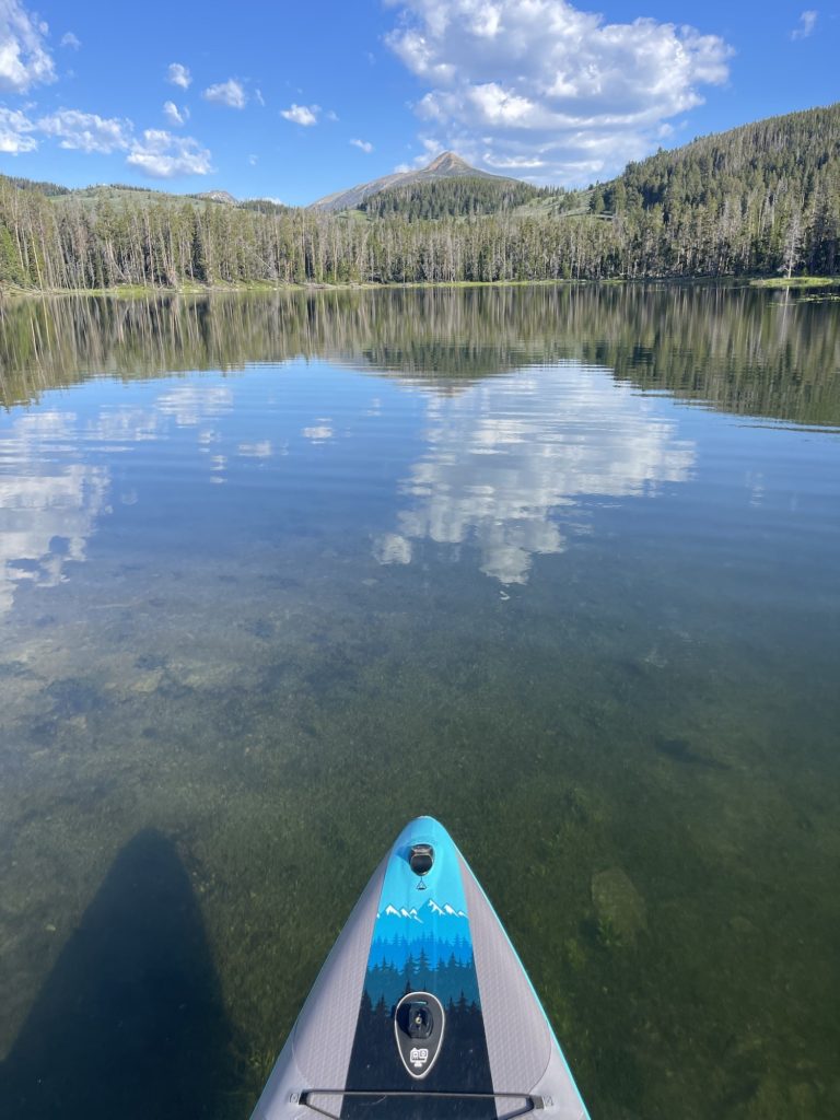 paddle board in waters of sureshot lake