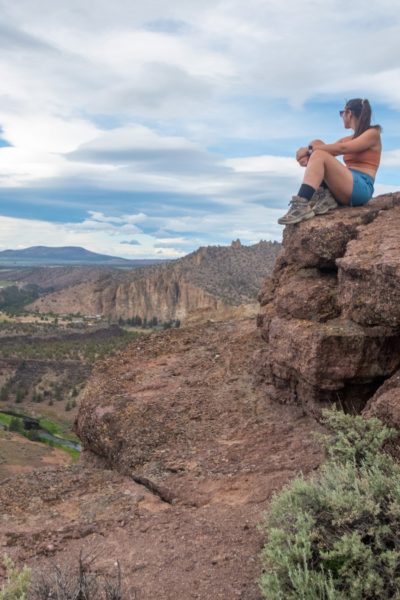 girl sittin gon rock at smith rock state park