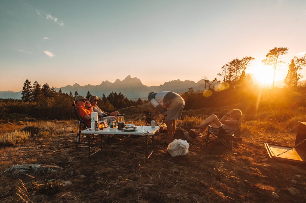 family at campsite in tetons with sunsetting