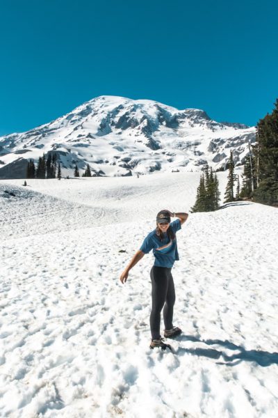 girl on snow in front of mount rainier