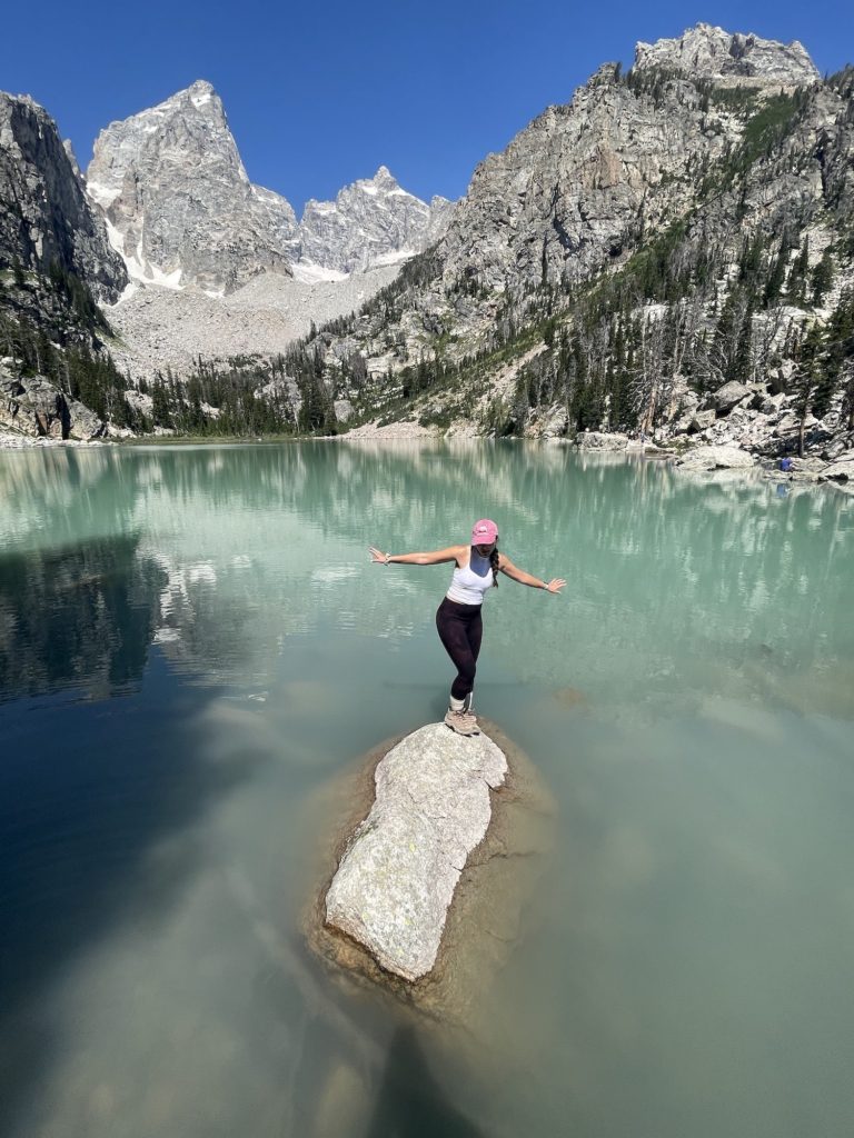 girl on boulder in delta lake