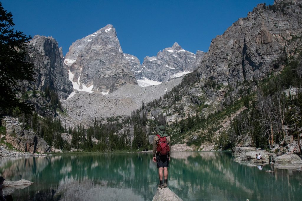 boy in front of delta lake with backapck