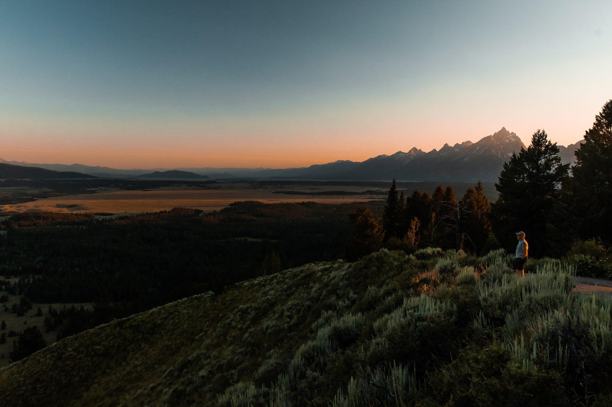 man standing watching sunset over signal mountain