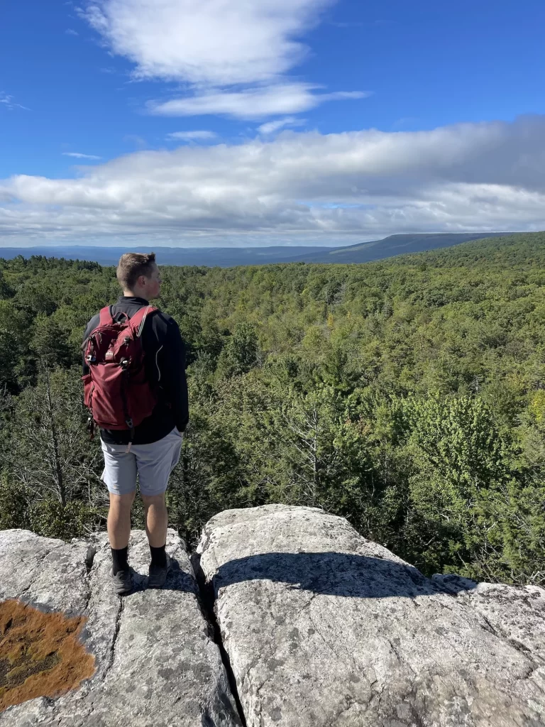 boy standing on rocks at the ridgeline