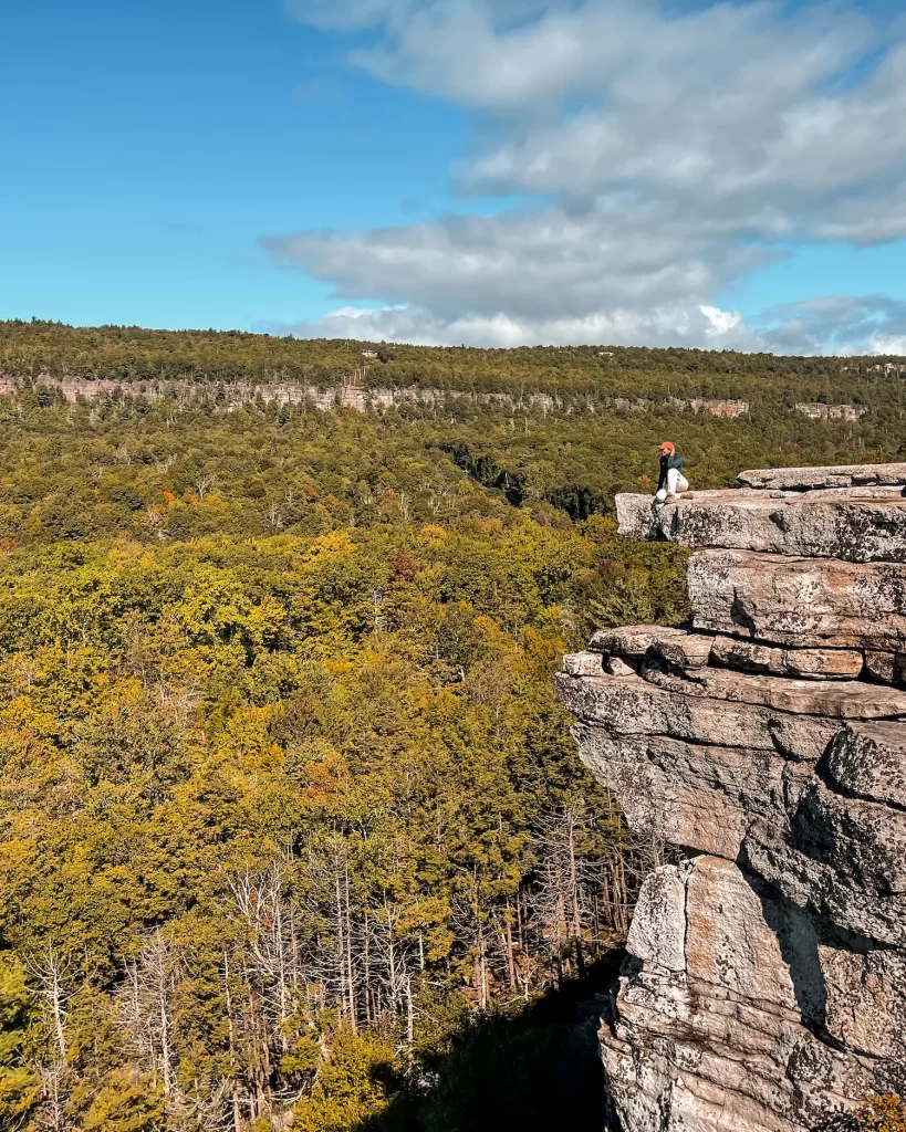 girl sitting on rocks at gertrude's nose
