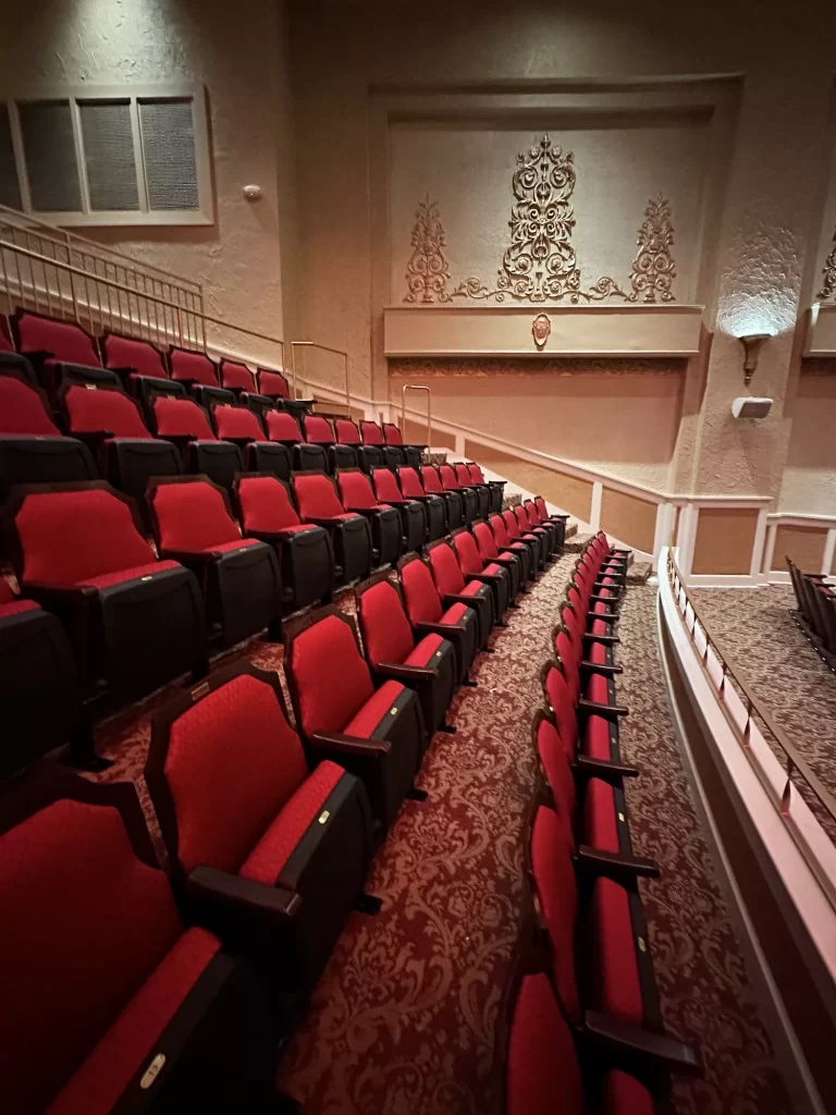 Inside of the old Granada Theater with red seats lining the rows