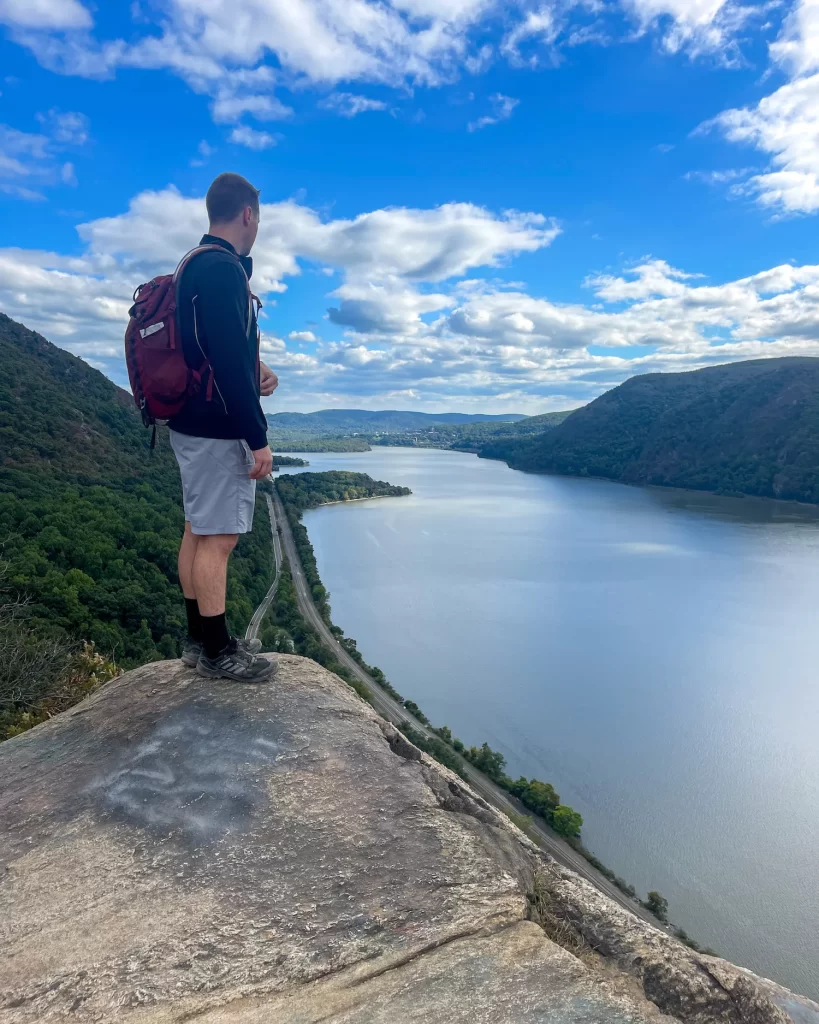 boy standing on a rock overlooking Hudson River