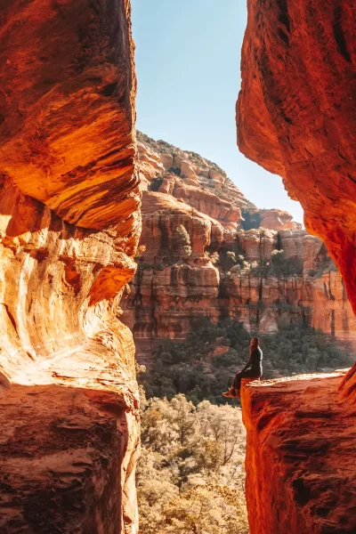 girl sitting on the ledge of the subway cave trail in sedona