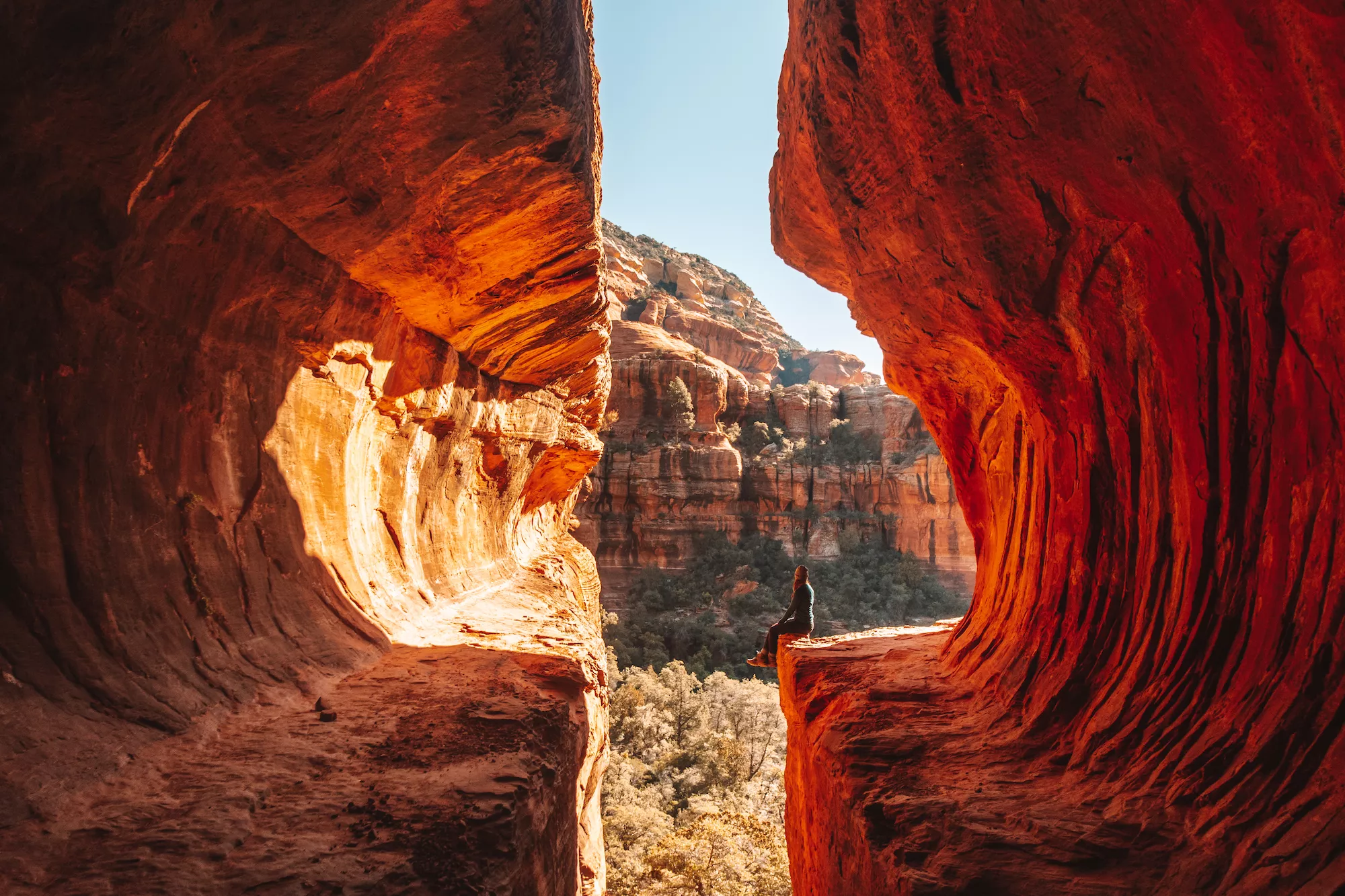 girl sitting on the ledge of the subway cave trail in sedona