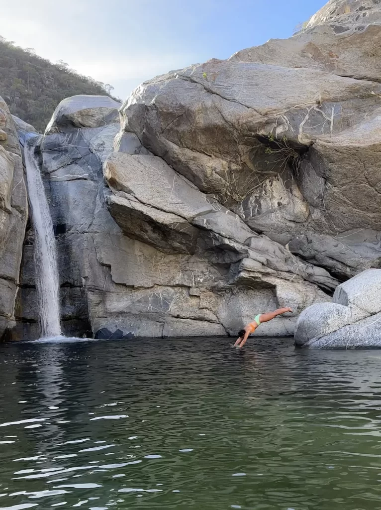 girl diving into Cañón de la Zorra