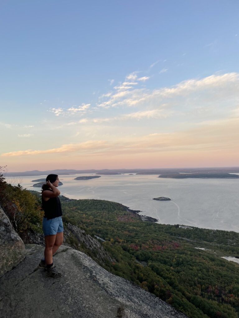 girl standing on a ledge of the precipice loop trail