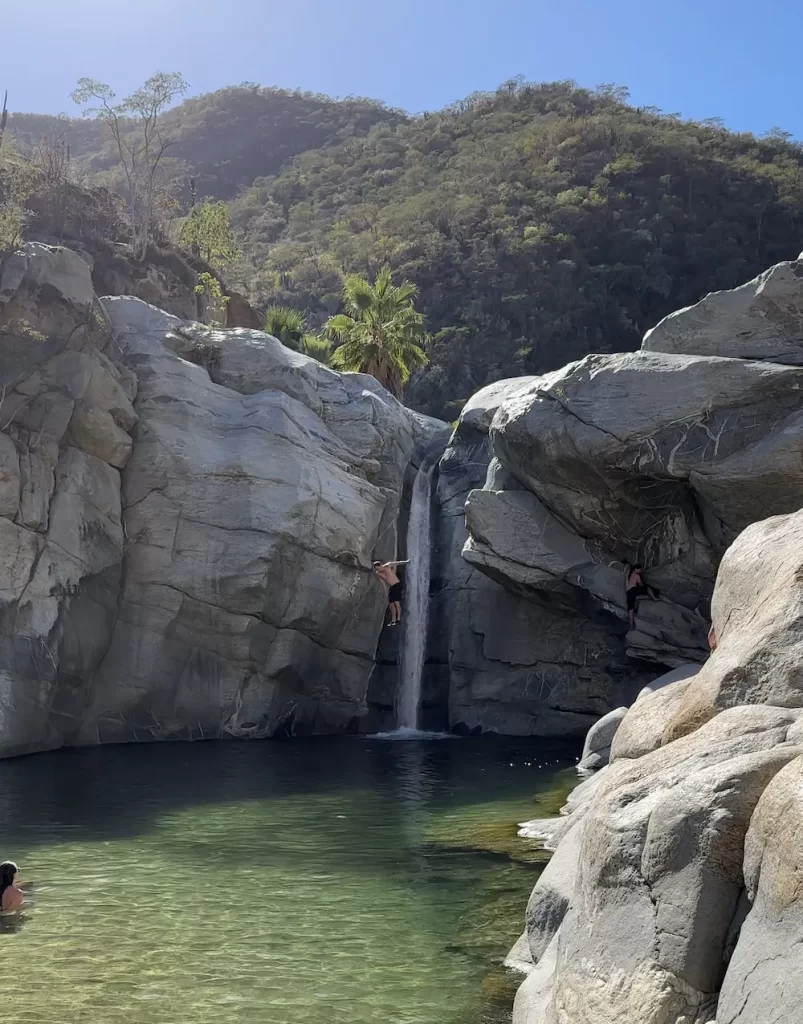 man jumping into the pool below