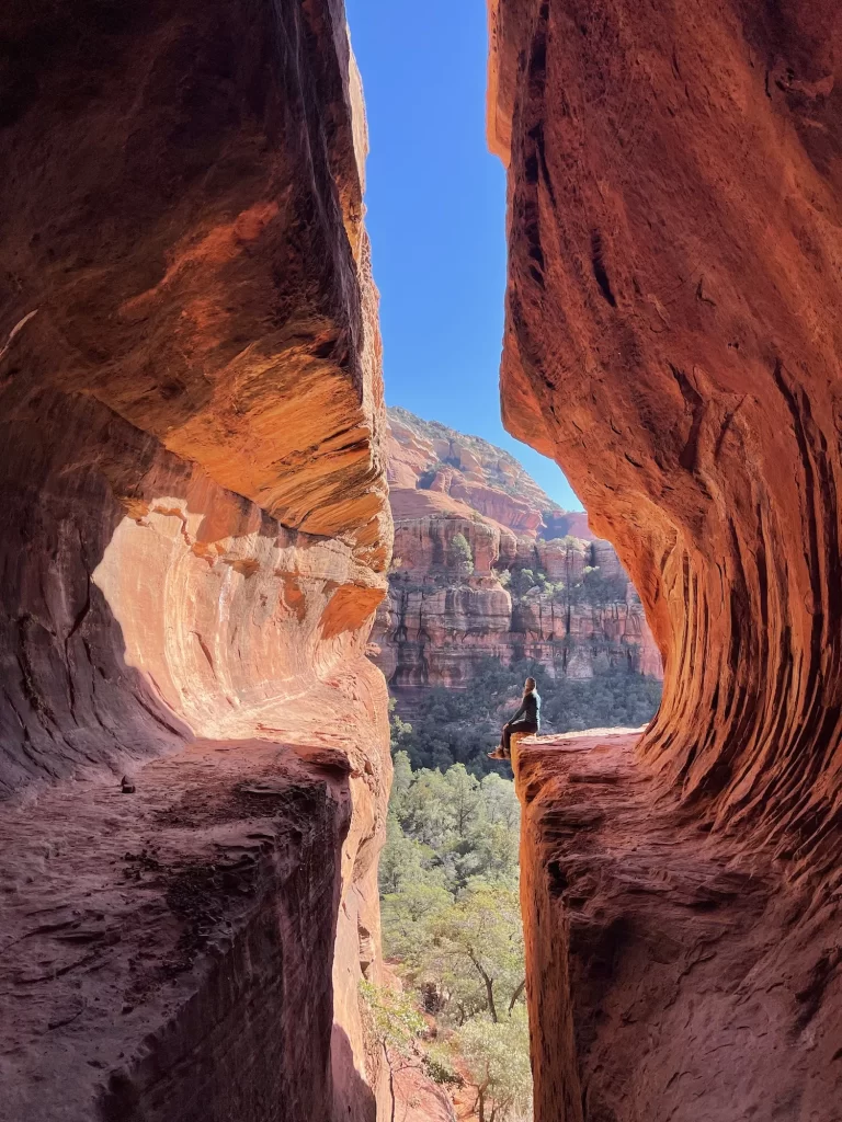 girl sitting on the ledge of the subway cave trail