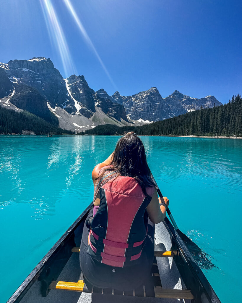 girl canoeing on the water of Moraine Lake