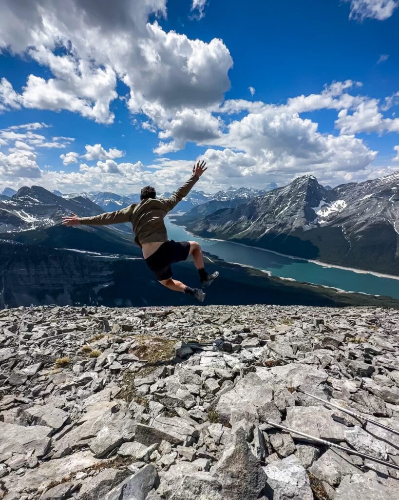 boy leaping and kicking feet at the summit