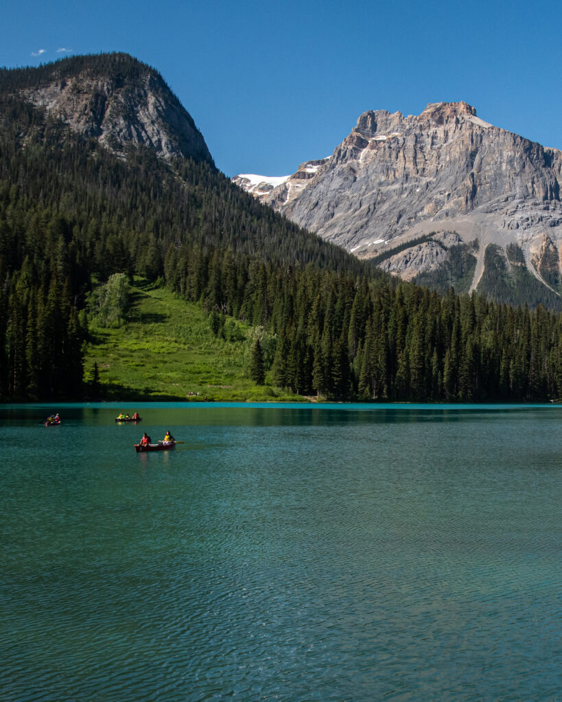 pictures of boats on Emerald Lake in Yoho National Park. The lake is a stunning shade of greenish blue